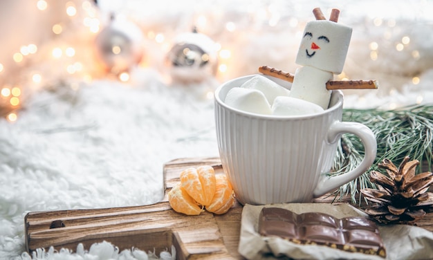 Free photo christmas background with marshmallow snowman in a cup